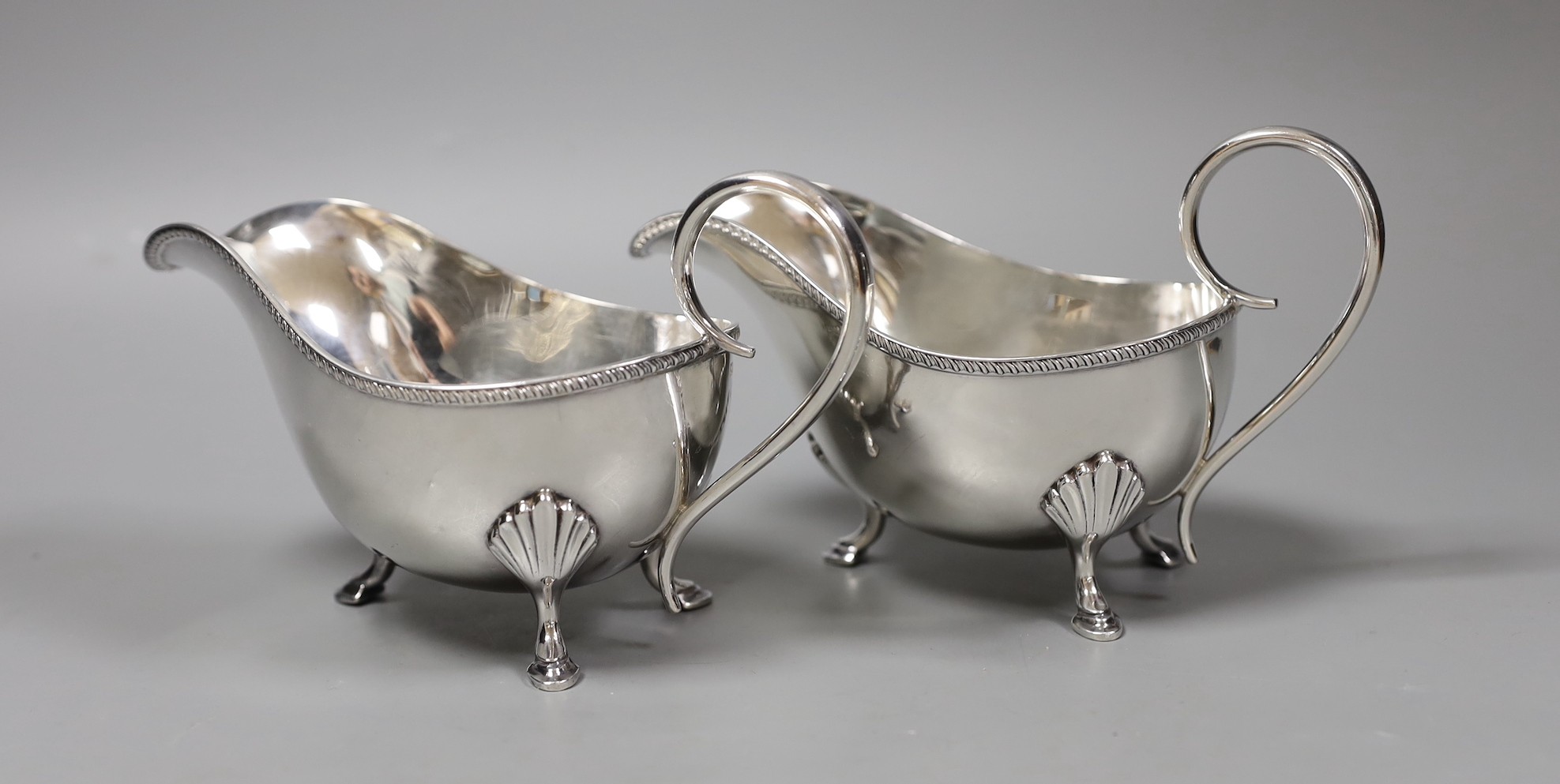 A pair of George V silver sauceboats, John Henry Potter, Sheffield 1930, length 19cm, 17oz.
